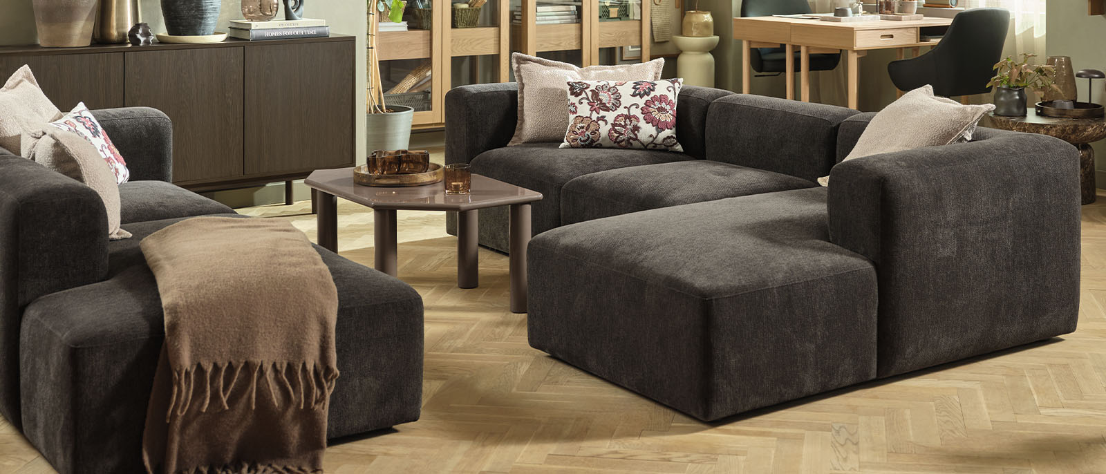 Learn more about what makes a modular sofa a great choice for your home Dark brown modular corner sofa in large seating setup in living