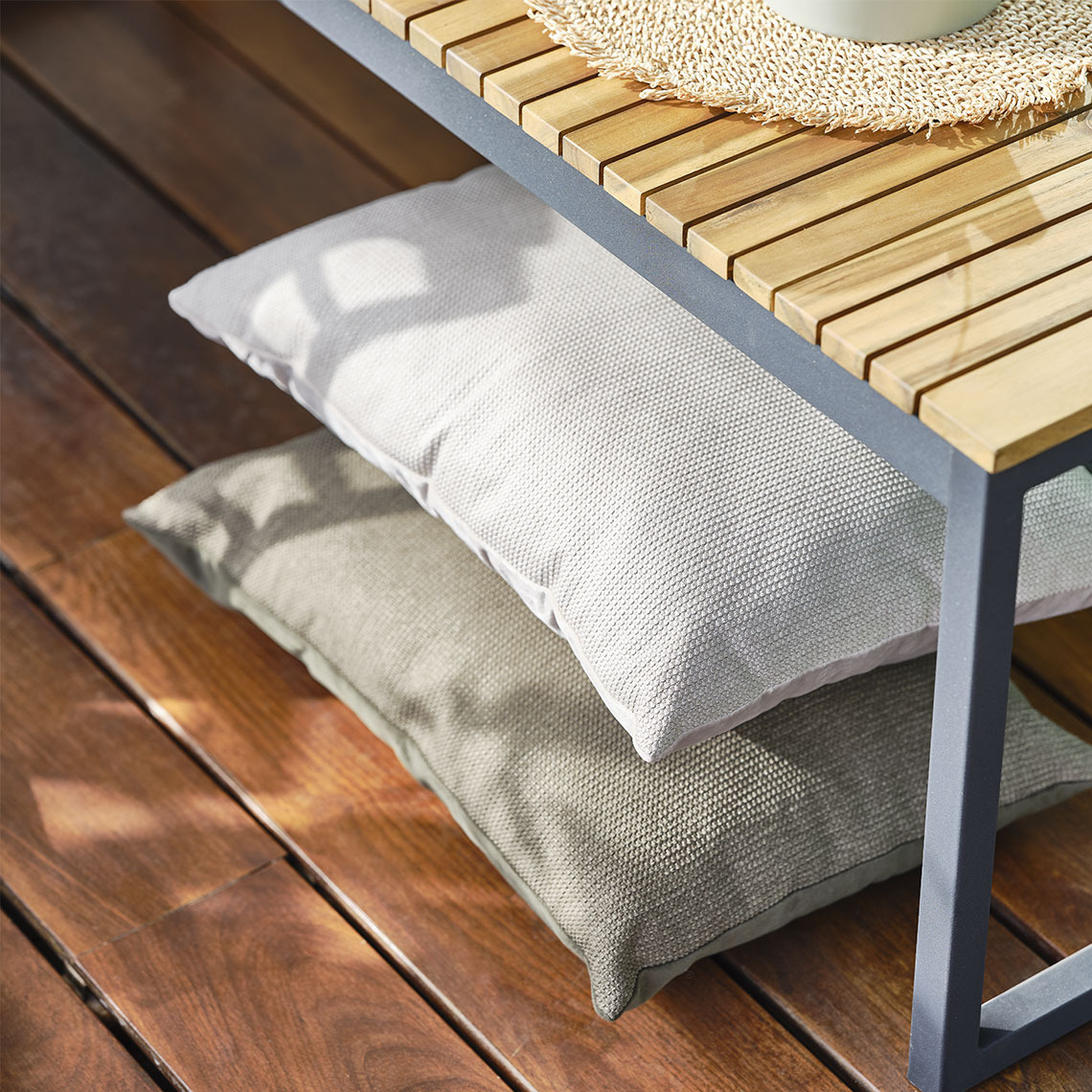 Beige cushions under a garden bench