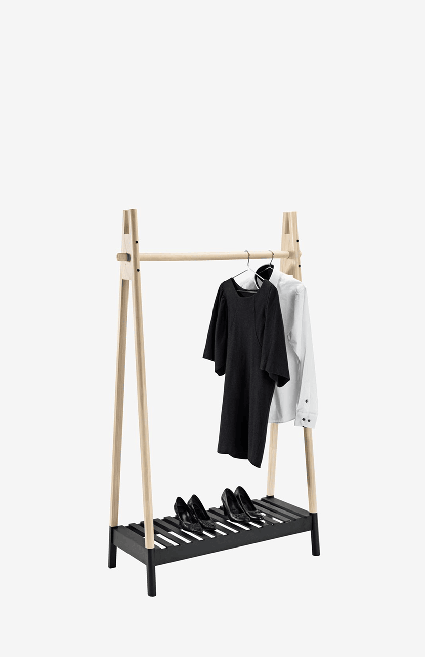 Clothes rails Natural wood A-frame clothes rail with a black shoe shelf, hung with a black dress and white shirt, and black heels below.