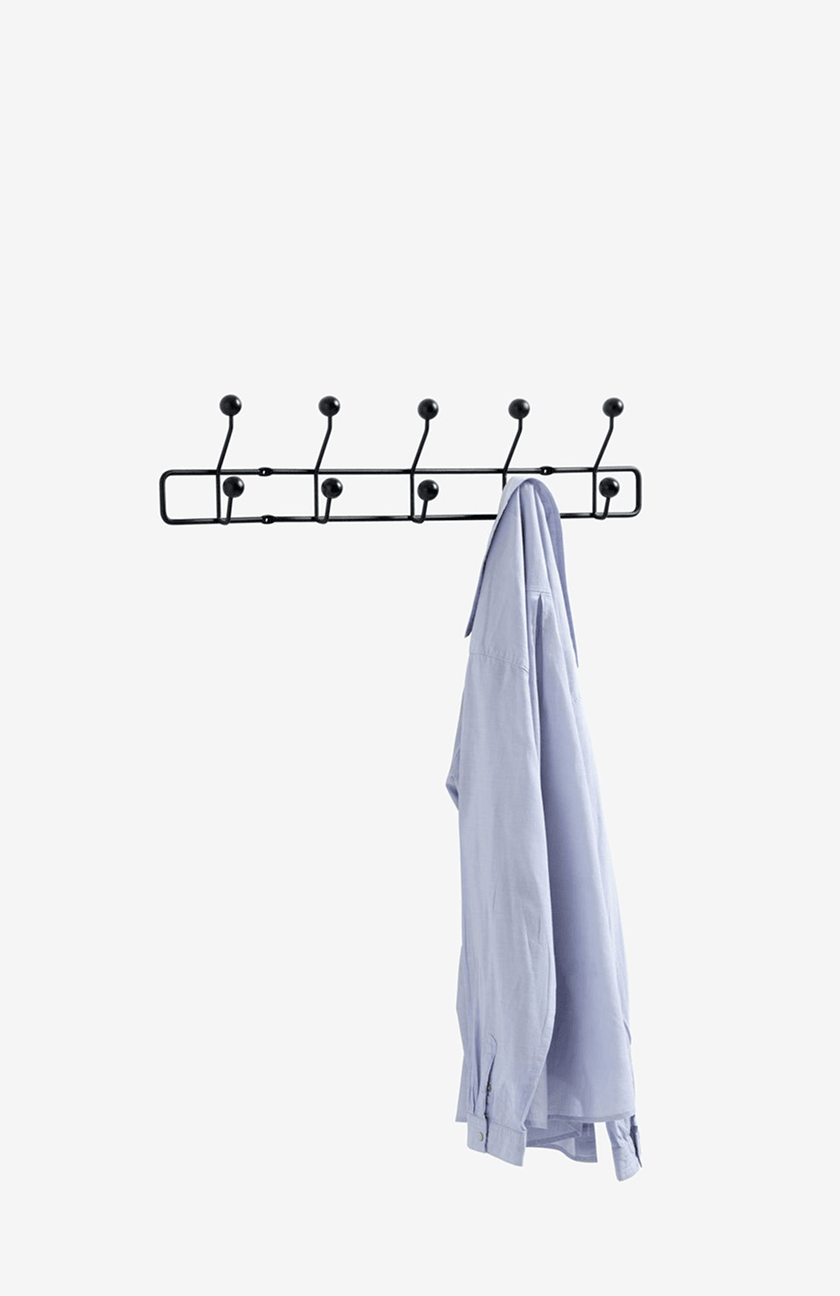 Coat racks Black wall-mounted coat rack with five double hooks, holding a light blue shirt.