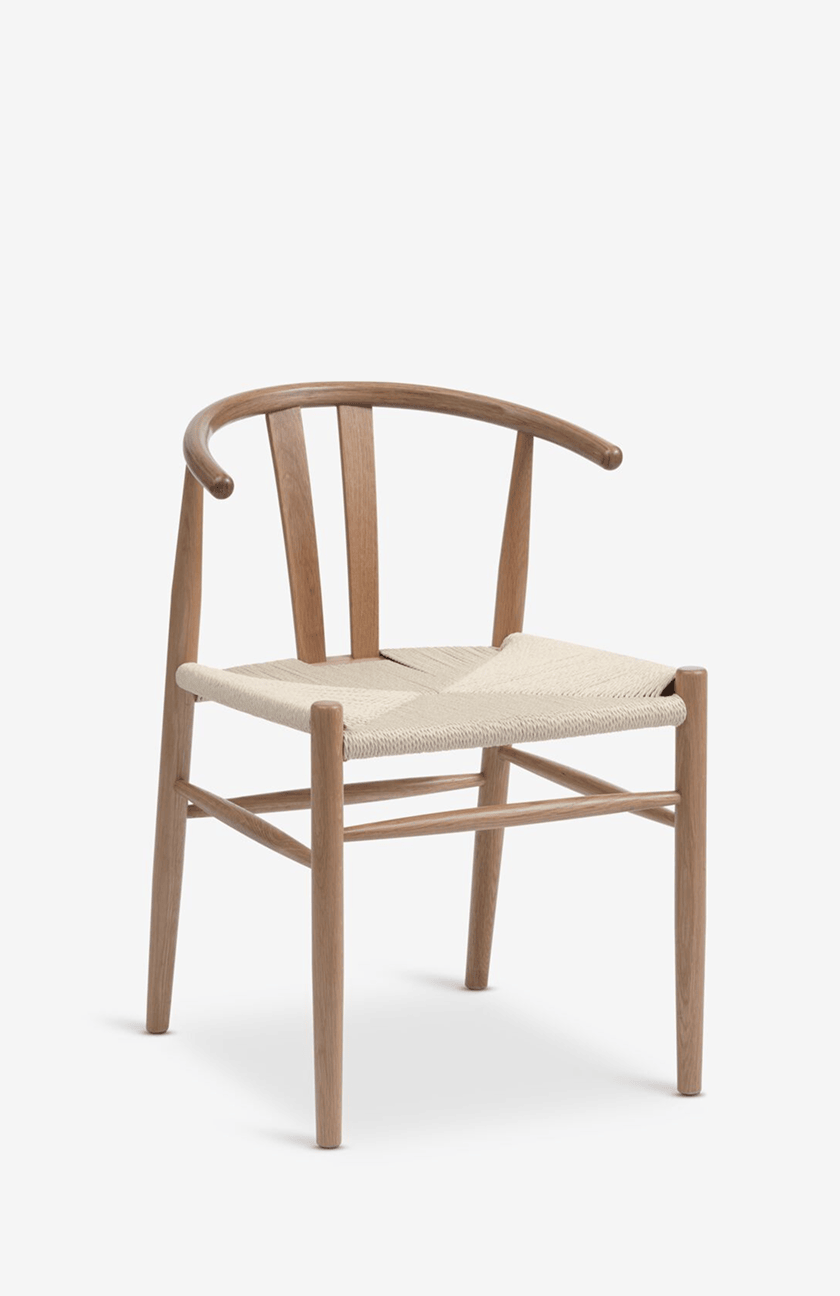 Dining chairs Oak wishbone-style dining chair with a curved backrest and a woven paper cord seat, shown against a plain white background.