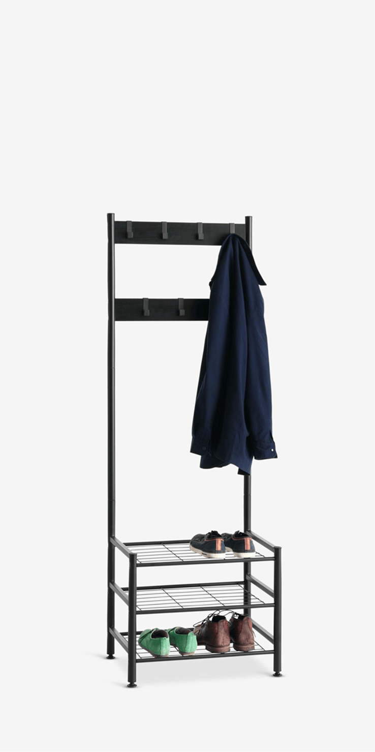 Hallway units Black metal hall tree with double coat hooks and a three-tier shoe shelf, holding a navy shirt and pairs of shoes.