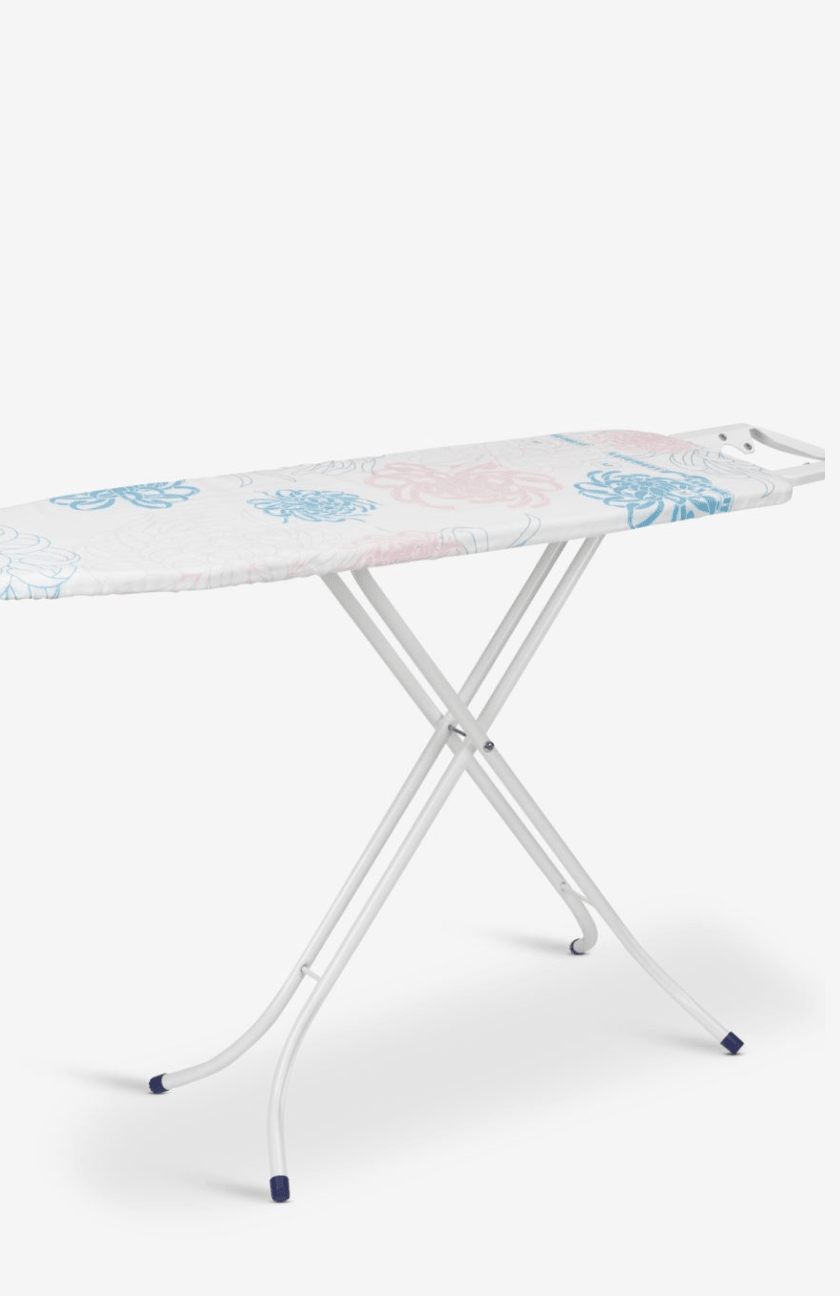 Ironing boards White ironing board with a folding leg stand and a pink and blue floral-patterned cover, shown against a plain white background.