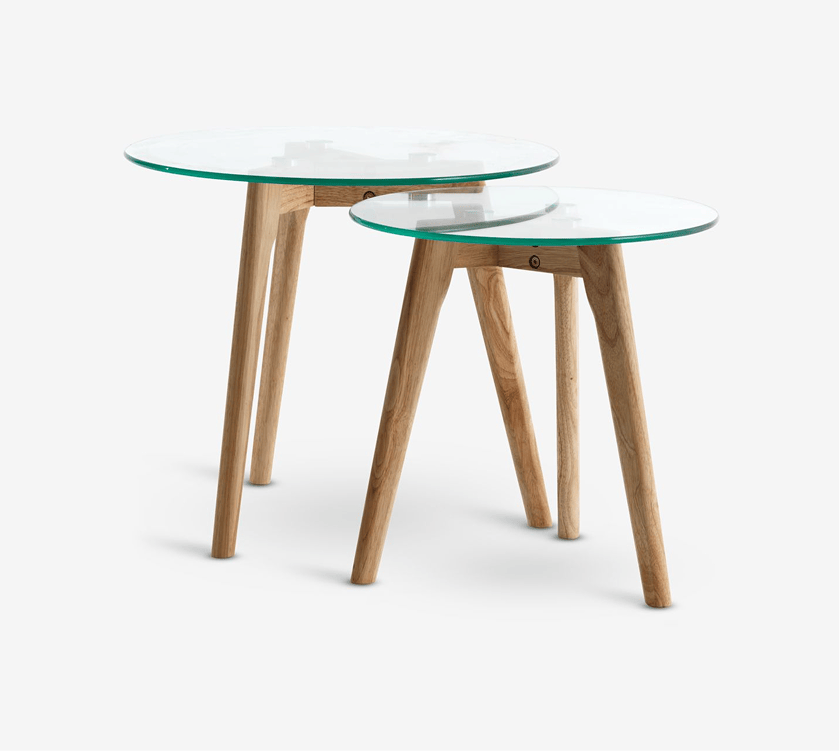Materials Two round glass-top nesting tables with light oak legs, shown against a plain white background.