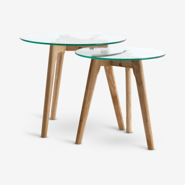 Materials Two round glass-top nesting tables with light oak legs, shown against a plain white background.