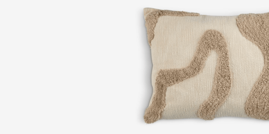 Cushions Cream lumbar cushion with a tufted beige abstract swirl pattern, shown against a plain white background.
