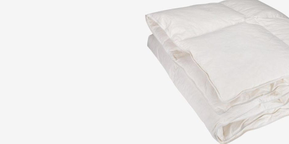 Duvets Folded white duvet with a quilted box pattern, shown against a plain light grey background.