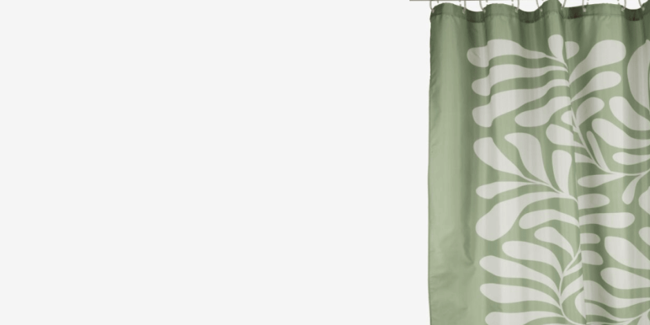 Shower curtains Sage green shower curtain with a white leaf pattern, hanging from a rod against a plain light background.