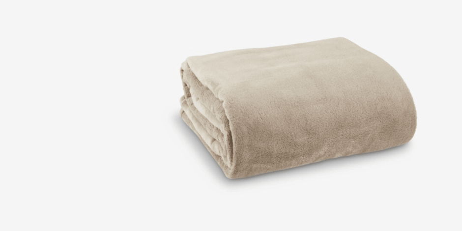 Throws Folded beige fleece throw blanket with a soft plush texture, shown against a plain light grey background.